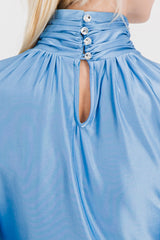 Draped blue high-neck top