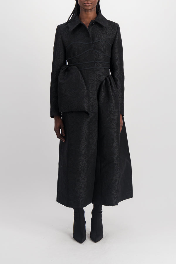 Fitted black coat with asymmetric side panels