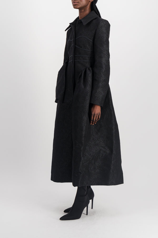 Fitted black coat with asymmetric side panels